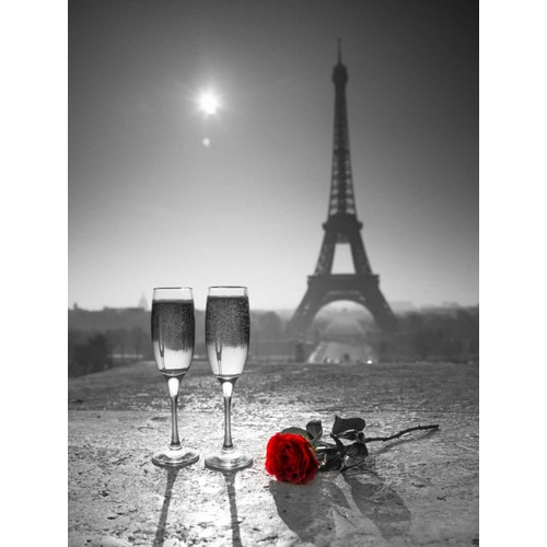 Champagne glasses with red rose next to the Eiffel tower