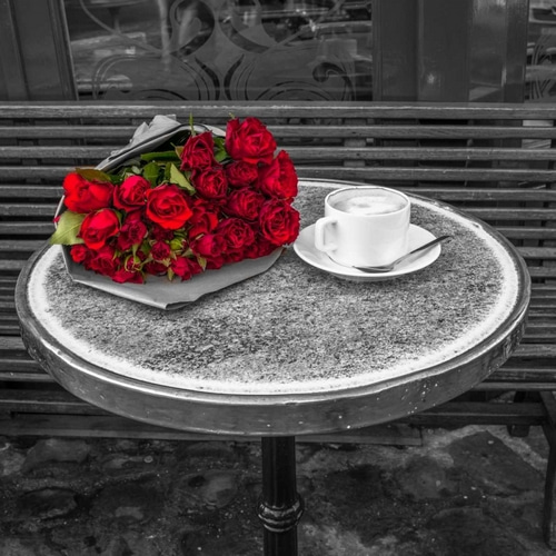 Bunch of flowers on sidewalk cafe table, Paris, France