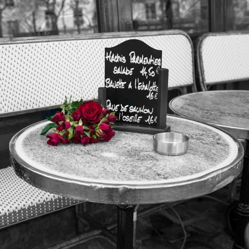 Bunch of flowers on sidewalk cafe table, Paris, France
