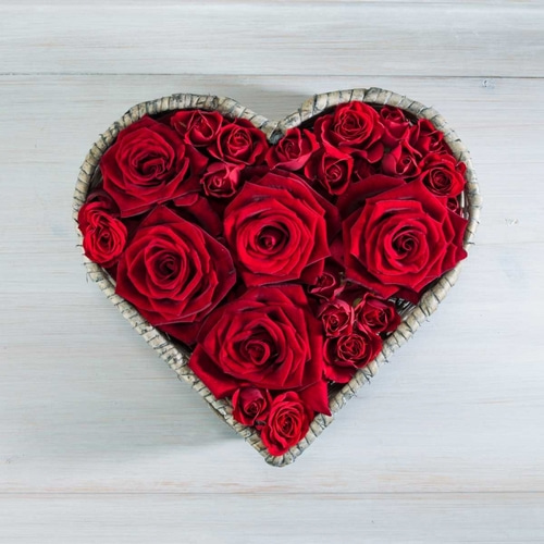 Roses in a heart shaped wicker basket