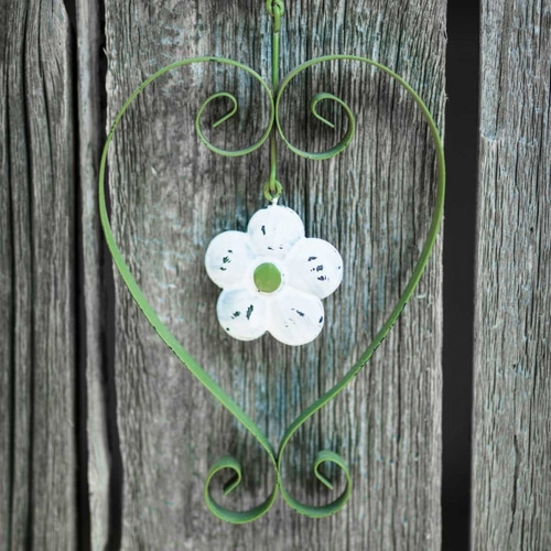 Heart shape with flower on wooden background