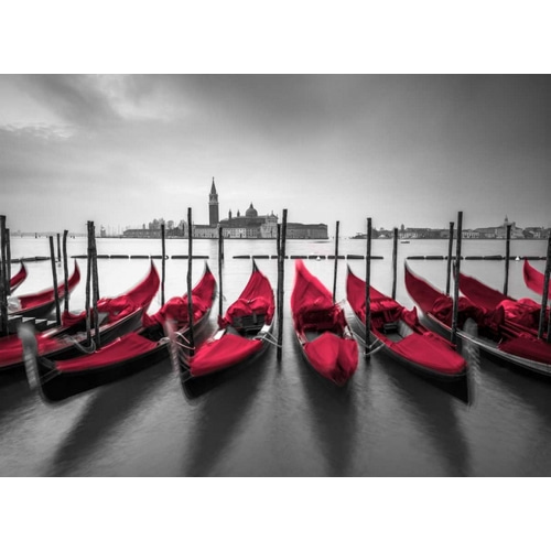 Bunch of Roses and umbrella on pier with gondolas moored in canal, Venice, Italy
