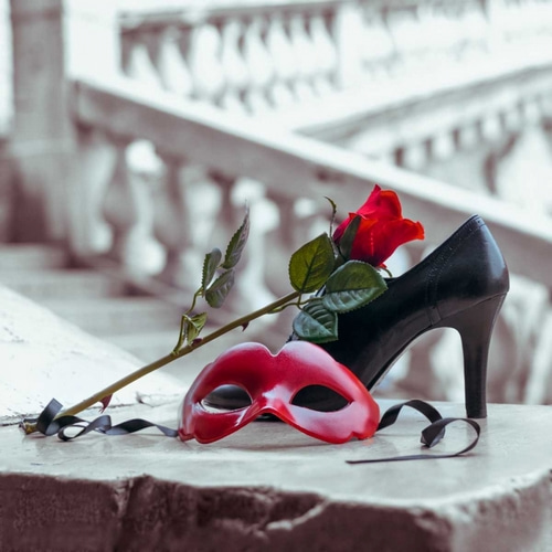 Venetian mask and high heel shoe with red rose, Rialto bridge, Venice, Italy