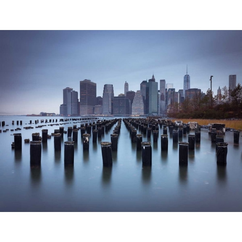 Lower Manhattan Skyline with pier pilings in east river, New York, USA