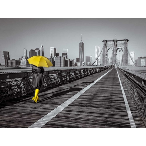 Female tourist with umbrella taking a walk on pedestrian walkway on Brooklyn bridge, New York