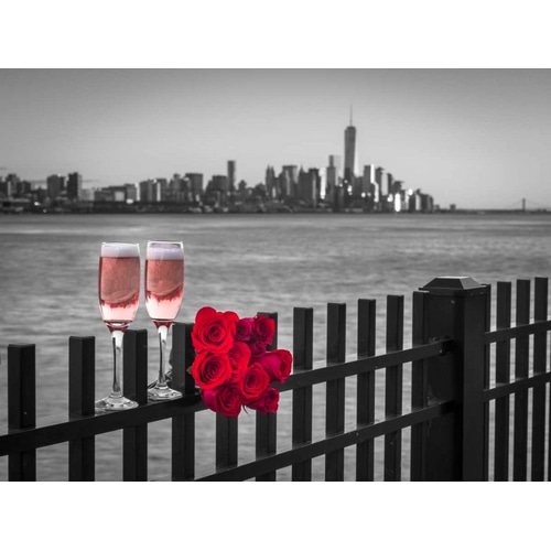 Glasses of Champagne with bunch of roses on railing against Lower Manhattan skylne, New York