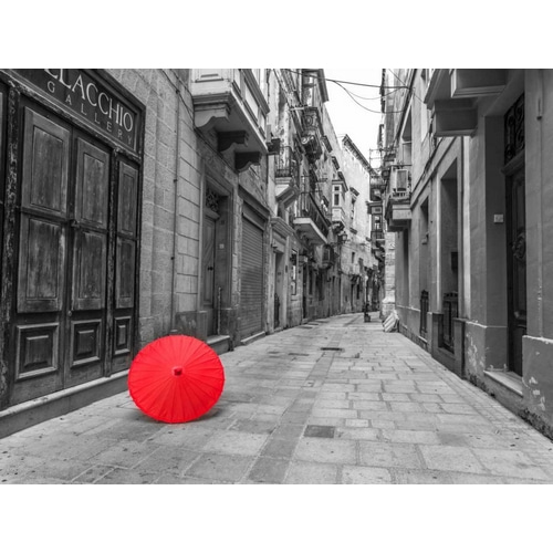 Red umbrella on narrow street of Birgu, malta
