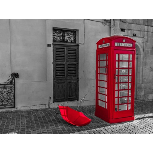 Red umbrella and Telephone box on street of Marsaxlokk, Malta