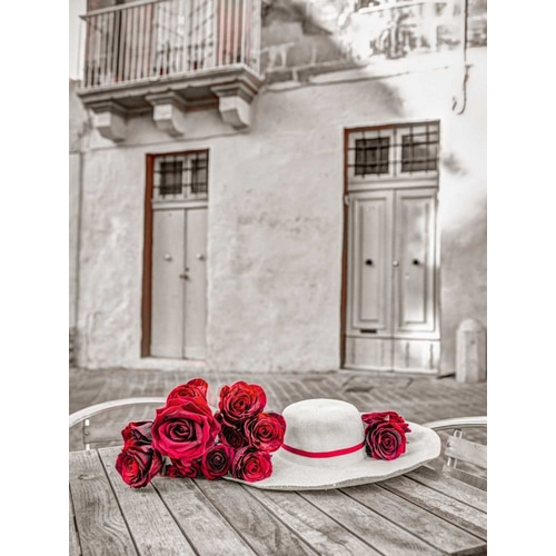 Female hat with bunch of roses on cafe table, Malta