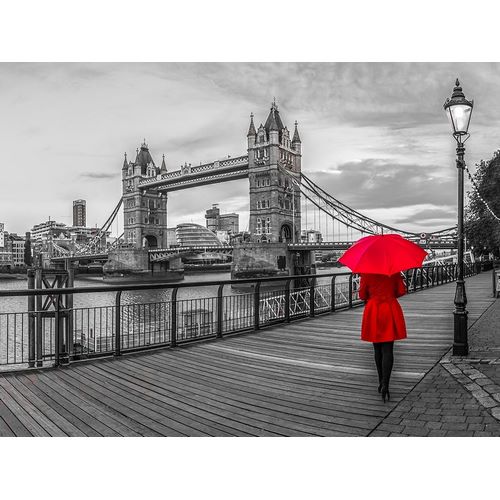 Tourist with red umbrella on promenade near Tower bridge, London, UK