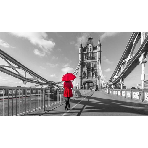 Tourist with red umbrella on Tower Bridge, London, UK