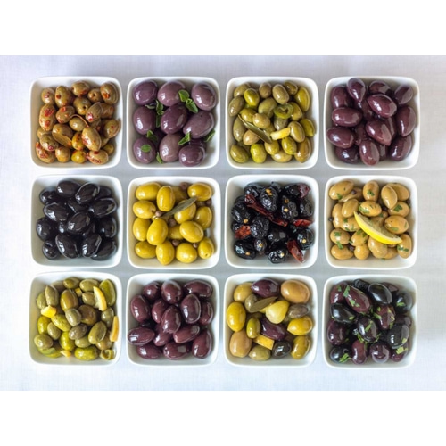 Varieties of Olives in bowls on white background