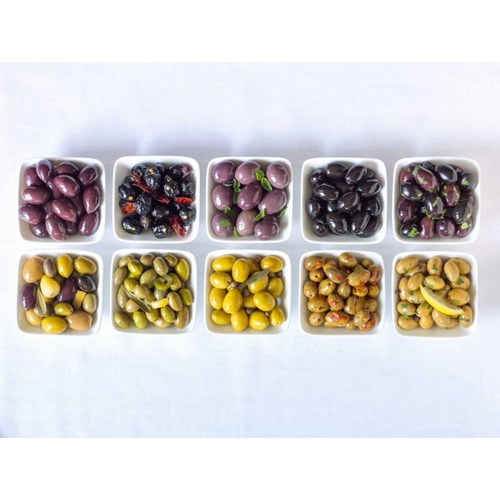 Varieties of Olives in bowls on white background