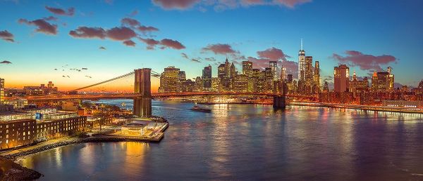 Evening view of Lower Manhattan skyline with Brooklyn bridge over East river, New York