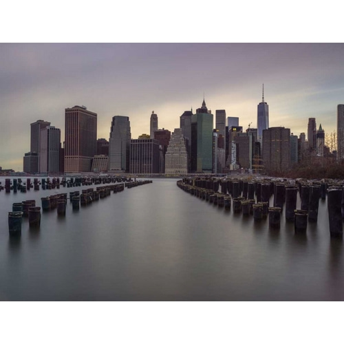 Manhattan skyline with rows of groynes in East river, New York