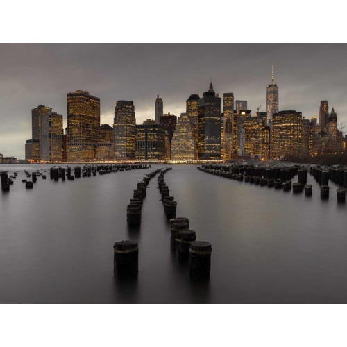 Manhattan skyline with rows of groynes in East river, New York