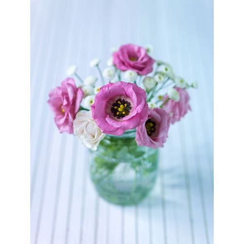 Colorful Lisianthus flowers in glass bottle