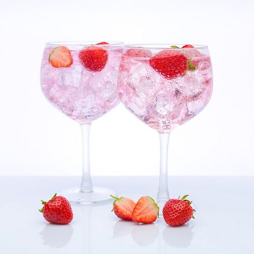 Gin with strawberries on white background