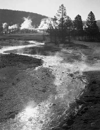 Stream winding back toward geyser, Central Geyser Basin, Yellowstone National Park, Wyoming, ca. 194
