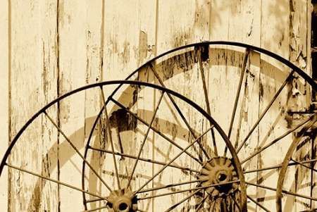 Old wagon wheels against a shed in Buffalo Gap Historic Village, near Abilene, TX - Sepia