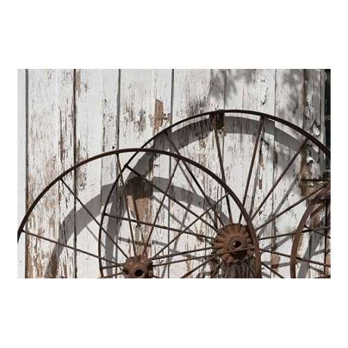 Old wagon wheels against a shed in Buffalo Gap Historic Village, near Abilene, TX