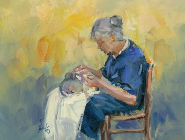 Elderly woman embroidering