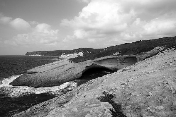 Flat rocks with natural arch on the coast of Sardinia Island ? black and white