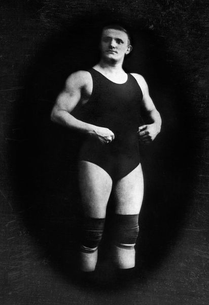 Bodybuilder in Wrestling Outfit and Knee Pads