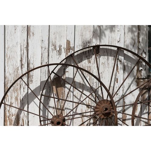 Old wagon wheels against a shed in Buffalo Gap Historic Village, near Abilene, TX