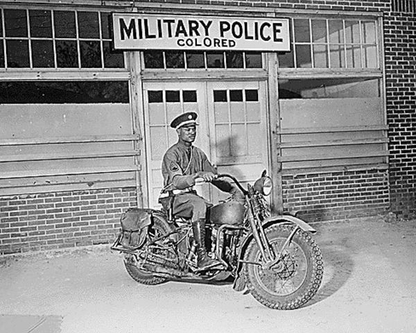 WWII An MP on motorcycle stands ready to answer all calls around his area. Columbus-Georgia